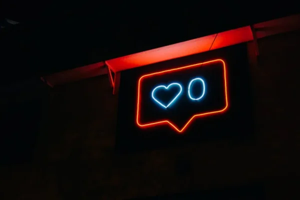 Bright neon heart icon with zero likes, symbolizing social media engagement.