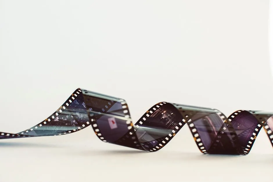 Close-up of a classic photographic film strip with a vintage feel against a white background.