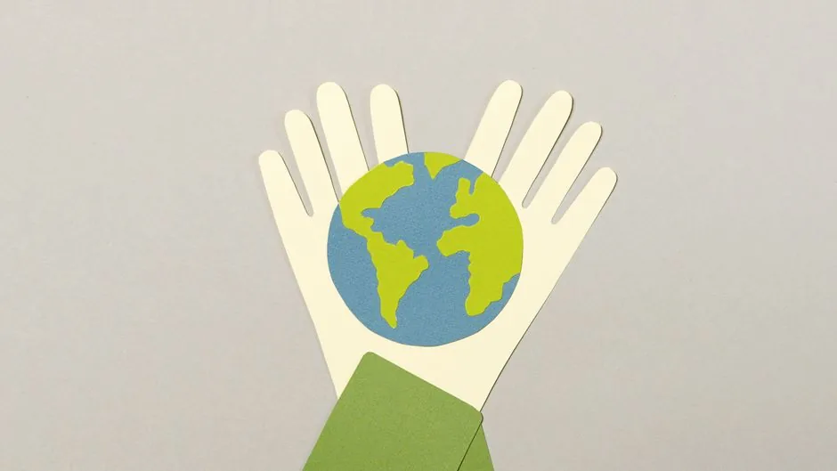 Creative paper cutout art representing Earth held by hands, symbolizes environmental protection.