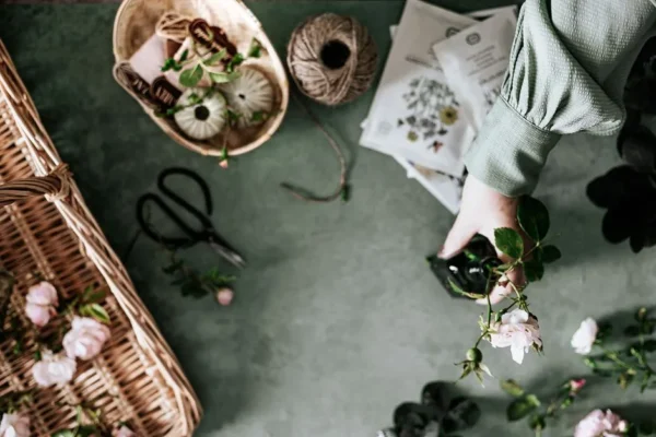 Elegant flat lay of flower arranging with tools and roses.