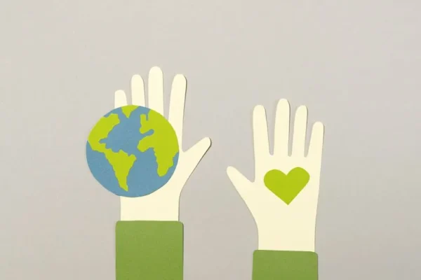 Creative paper cutout depicting environmental protection with Earth and heart symbols.