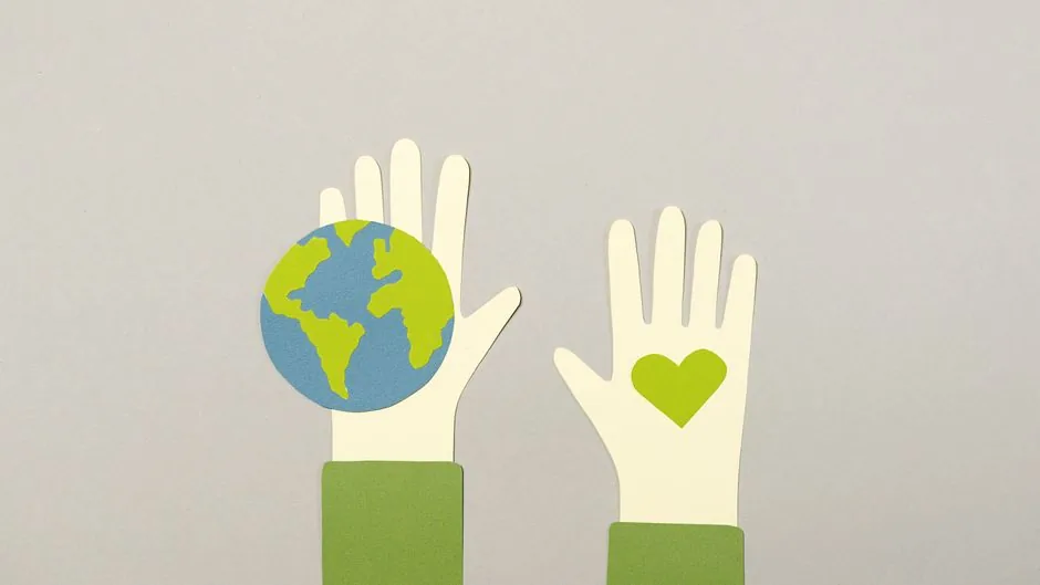 Creative paper cutout depicting environmental protection with Earth and heart symbols.